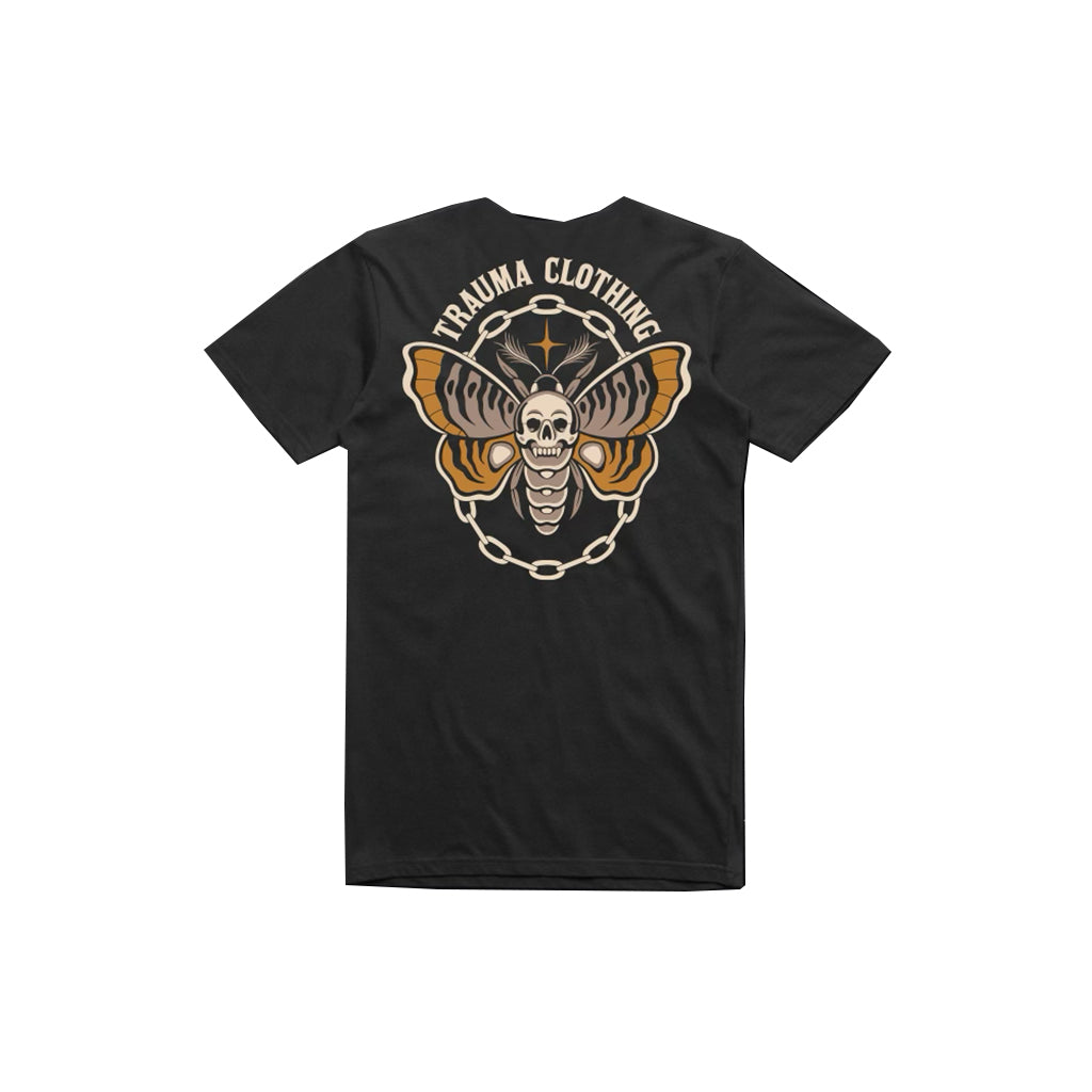 Black t-shirt with a skull and chain design on the back, branded 'Trauma Clothing', on a white background.