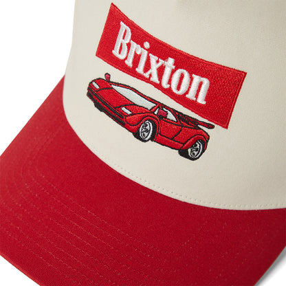 Red and beige cap with Brixton logo and car illustration on a white background