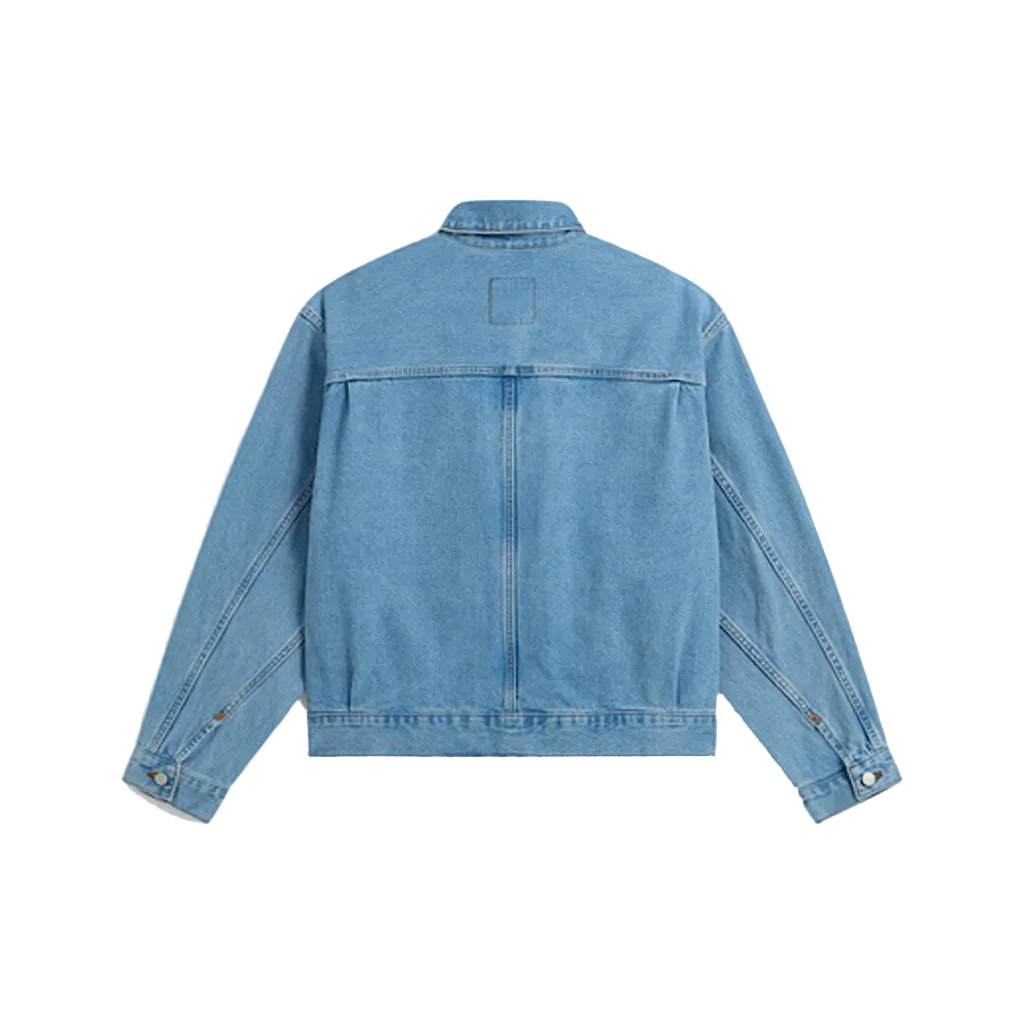 A light blue denim jacket shown from the back, featuring a buttoned collar, long sleeves, and a central seam, photographed against a solid light gray background.