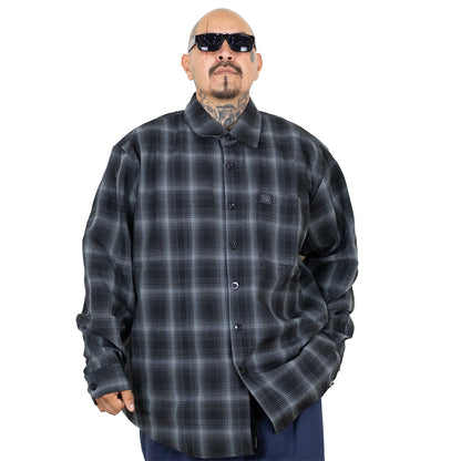 Man wearing a gray plaid shirt on a white background