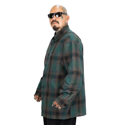 Man wearing a green plaid coat on a white background