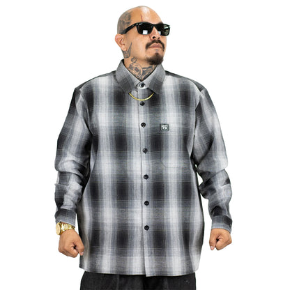Man wearing a gray and black plaid shirt on a white background