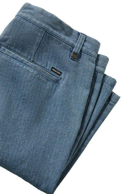 Folded blue shorts with a brand label on a light gray background