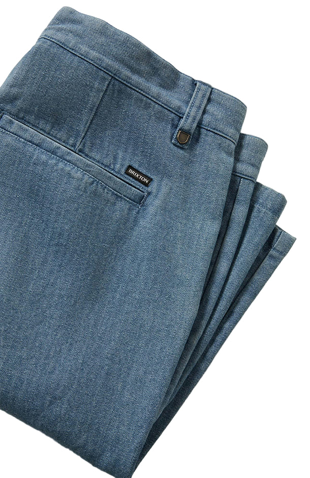 Folded blue shorts with a brand label on a light gray background