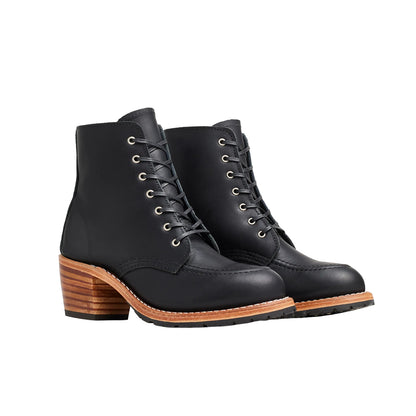 Black leather boots with wooden soles on a white background