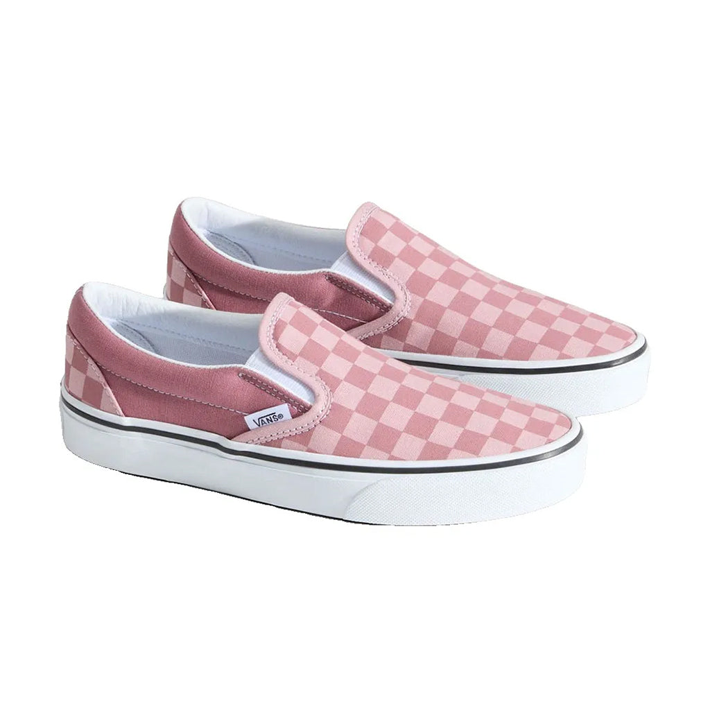 Pair of pink checkered slip-on shoes on a white background