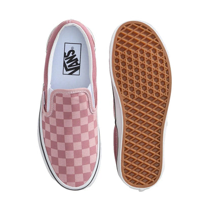Pink checkered slip-on Vans shoe with a brown sole on a white background