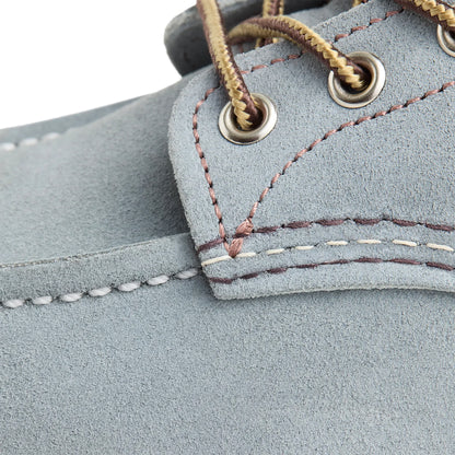 Close-up of a blue leather shoe with stitching details
