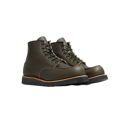 Pair of green leather boots on a white background