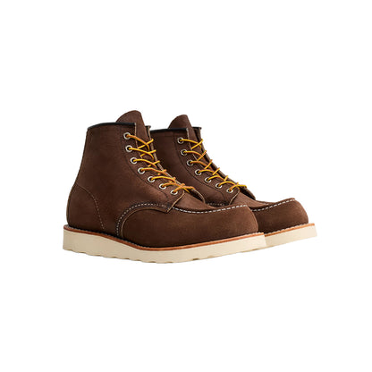 Pair of brown leather boots with yellow laces on a white background