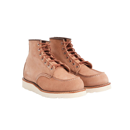 Pair of light pink leather boots on a white background