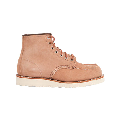Tan leather boot with a white sole on a white background