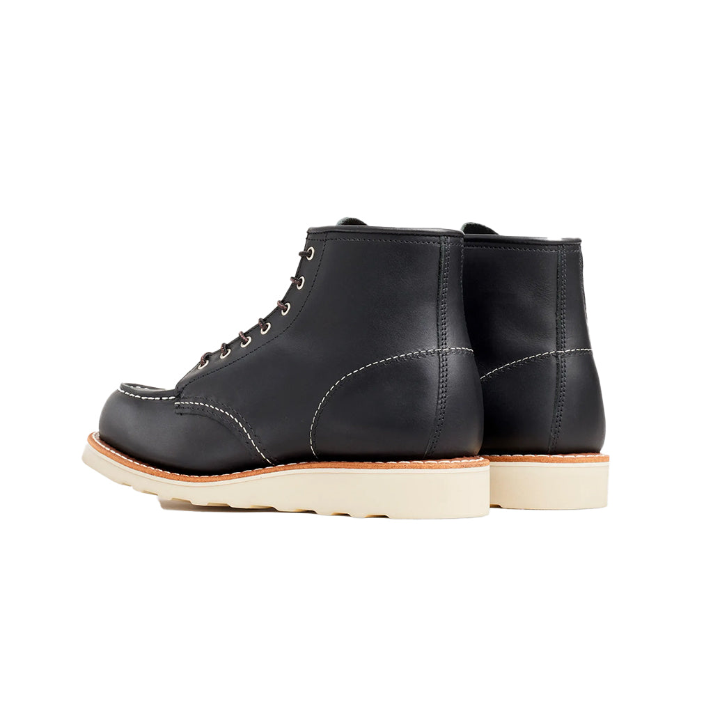 Black leather boots with white soles on a white background