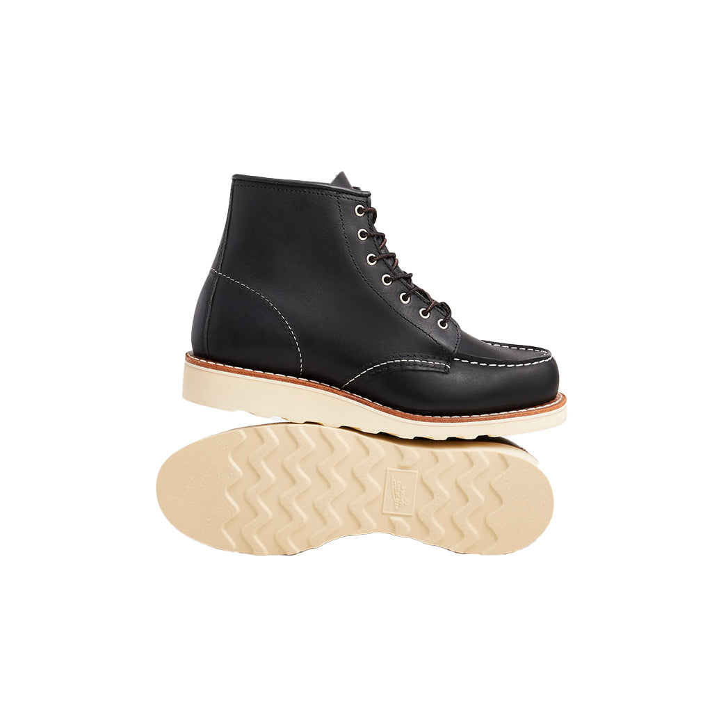Black leather boot with beige sole on a white background