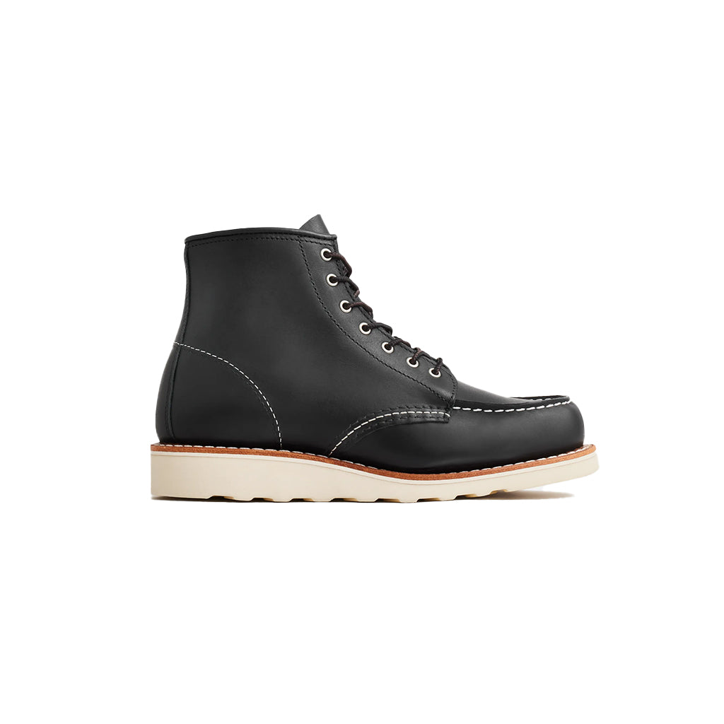 Black leather boot with a white sole on a white background