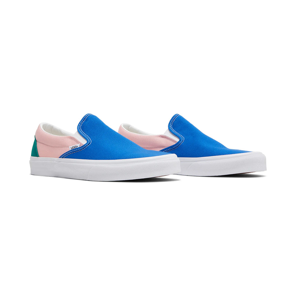 Blue slip-on sneakers with pink accents on a white background