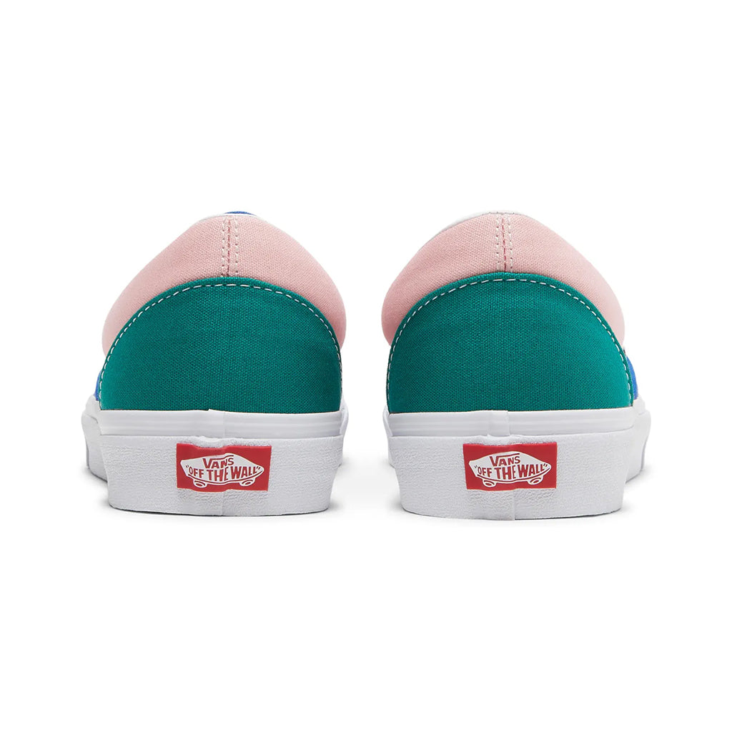 Pair of Vans sneakers with pink and teal design on a white background