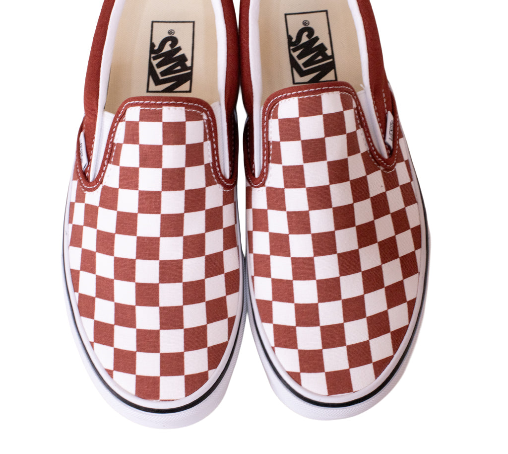 Pair of Vans checkered slip-on shoes on a white background