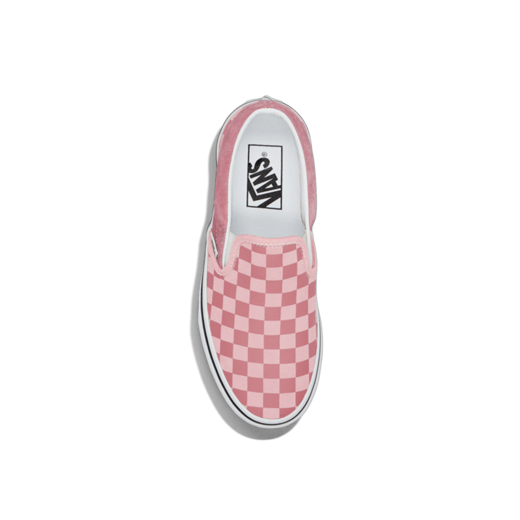 Pink checkered slip-on Vans shoe on a white background