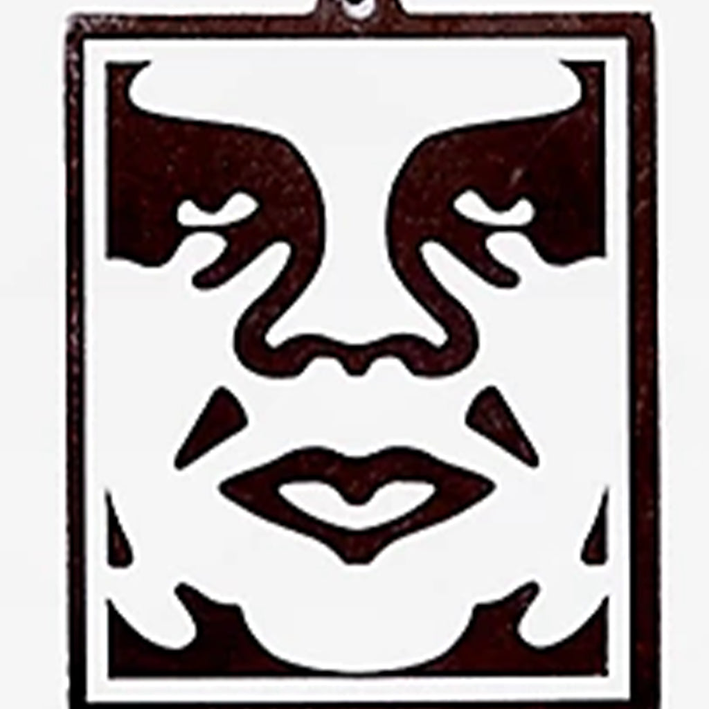 Decorative wall art with abstract face design on a white background