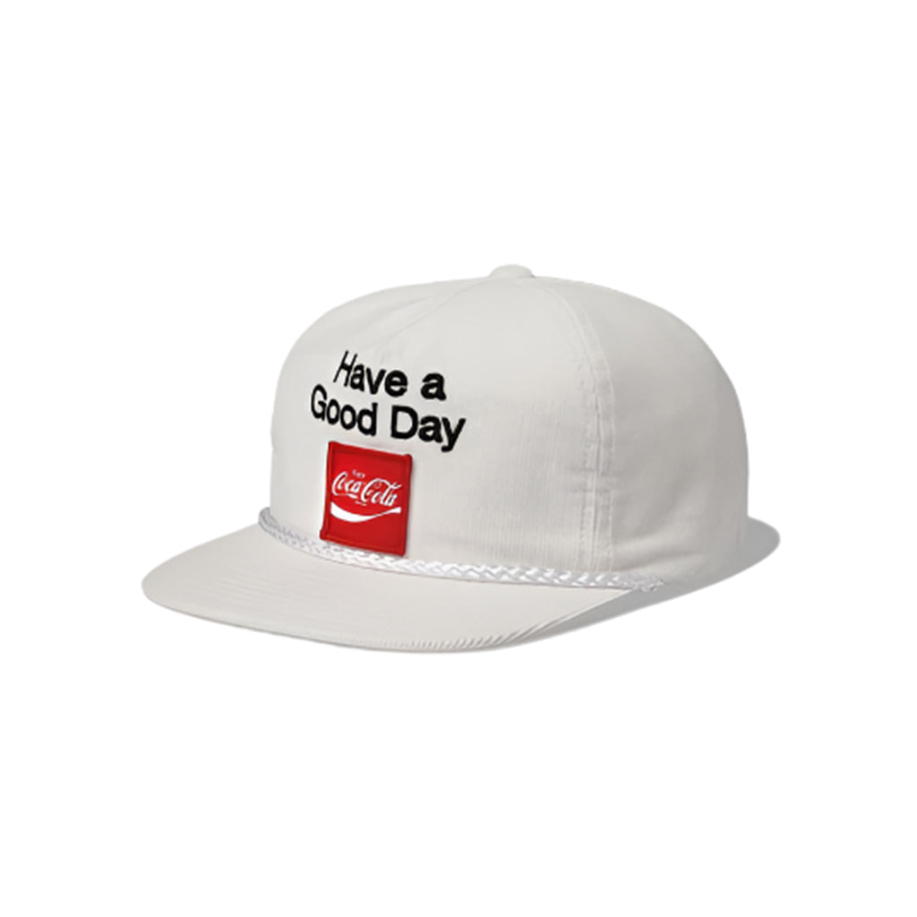 White cap with 'Have a Good Day' text and Coca-Cola logo on a white background