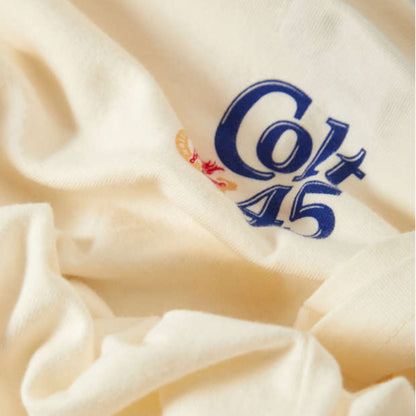 Close-up of a white fabric with 'Colt 45' logo embroidered on it.
