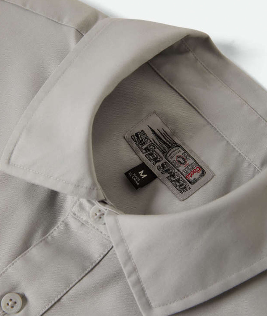 Close-up of a label on a beige shirt with a white background