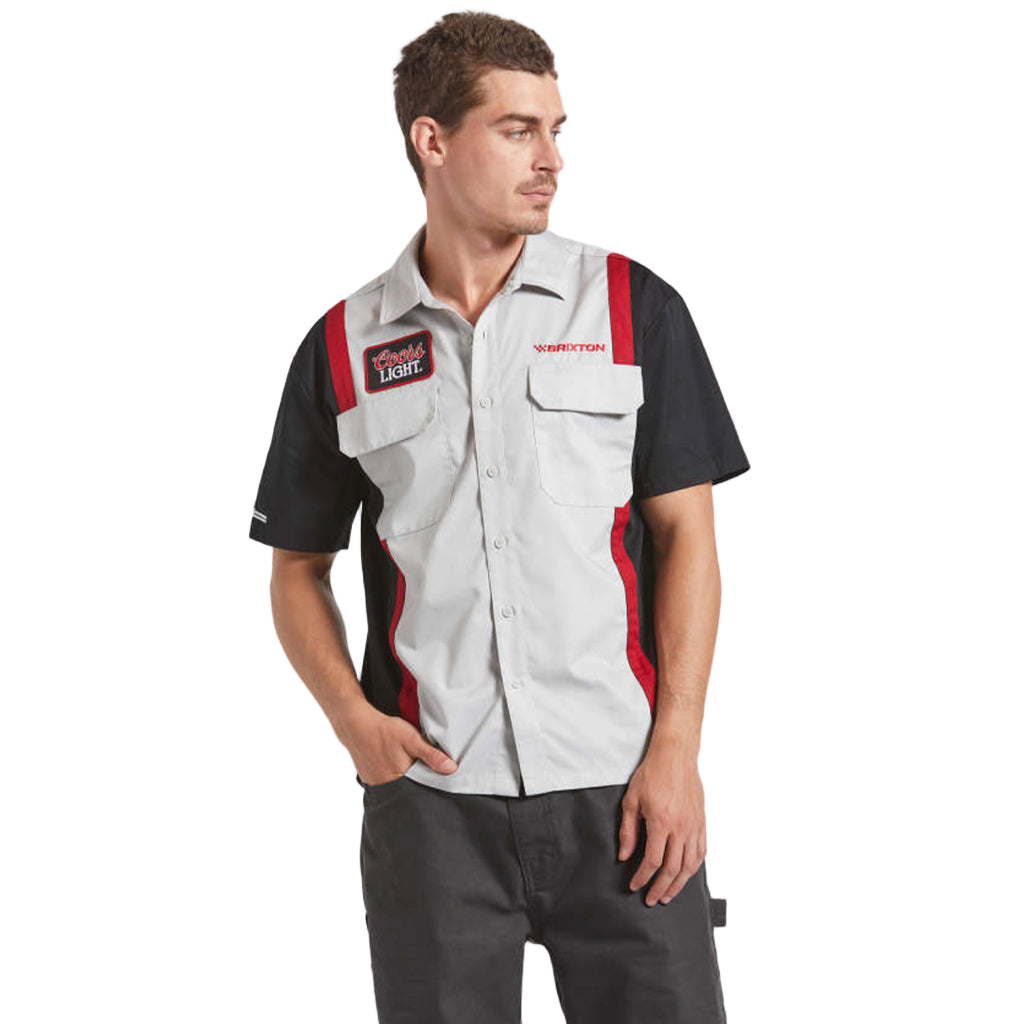 Man wearing a black and gray work vest with red accents on a white background