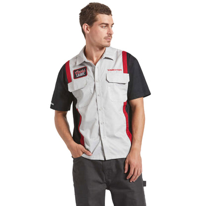 Man wearing a black and gray work vest with red accents on a white background