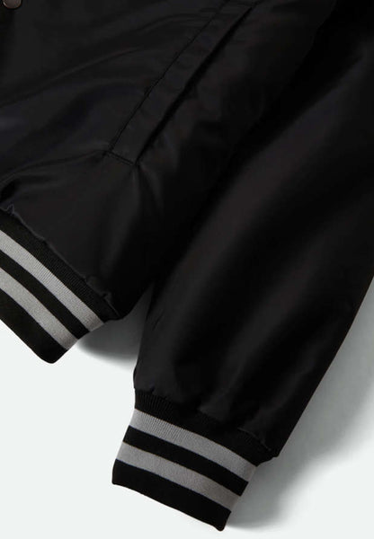 Close up of sleeve cuff and bottom of jacket on a white background