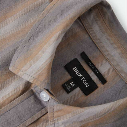 Close-up of a Brixton label on a plaid shirt