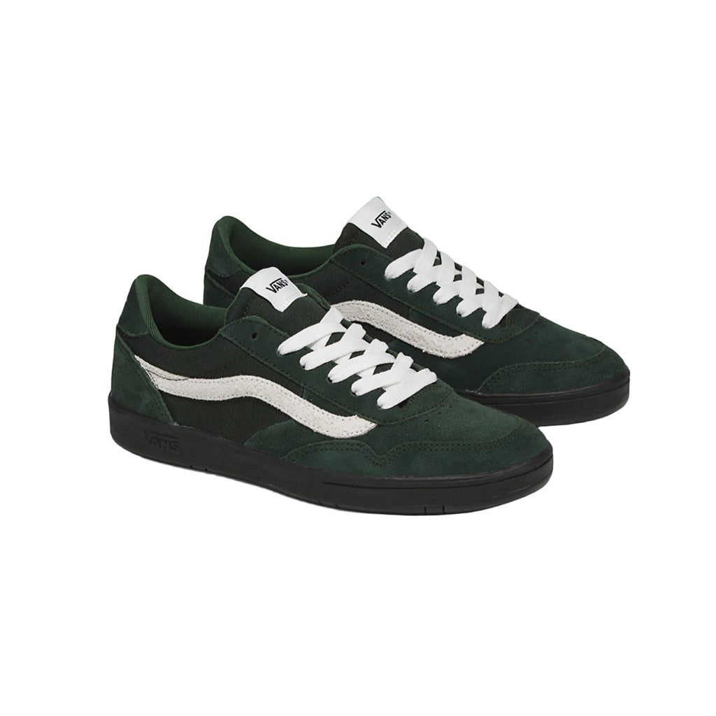 Green sneakers with white laces on a white background
