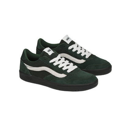 Green sneakers with white laces on a white background