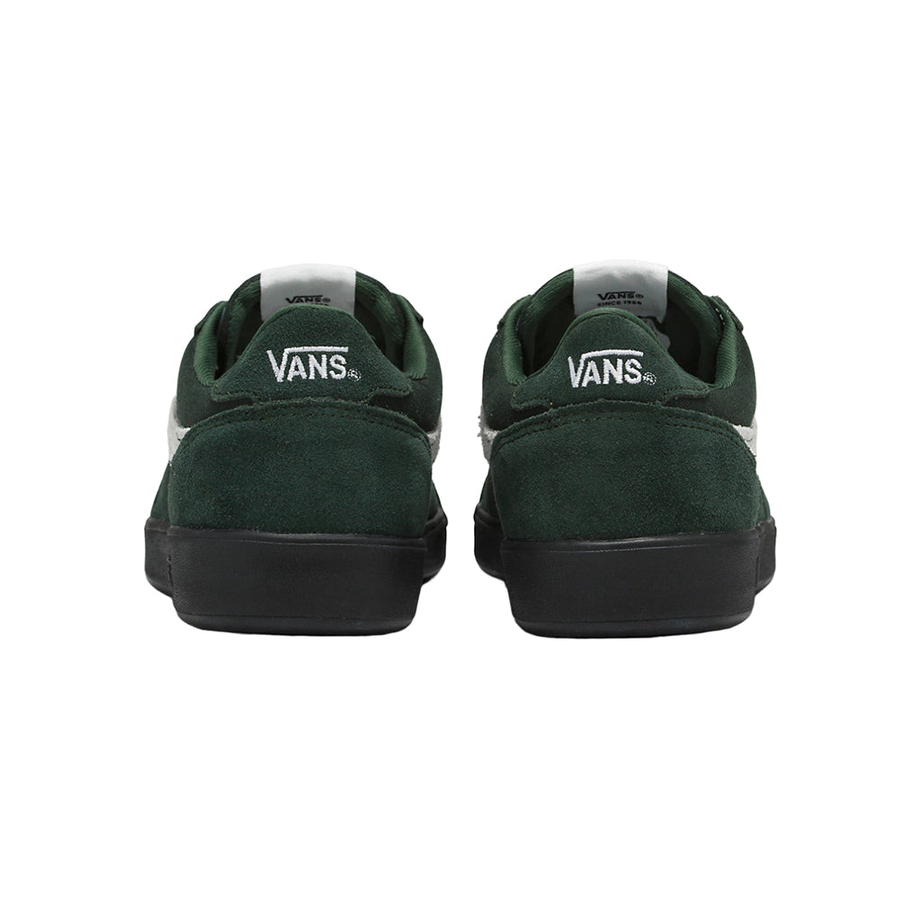 Green Vans sneakers shown from the back on a white background