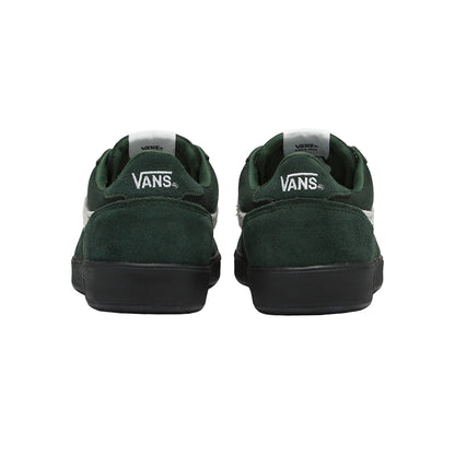 Green Vans sneakers shown from the back on a white background