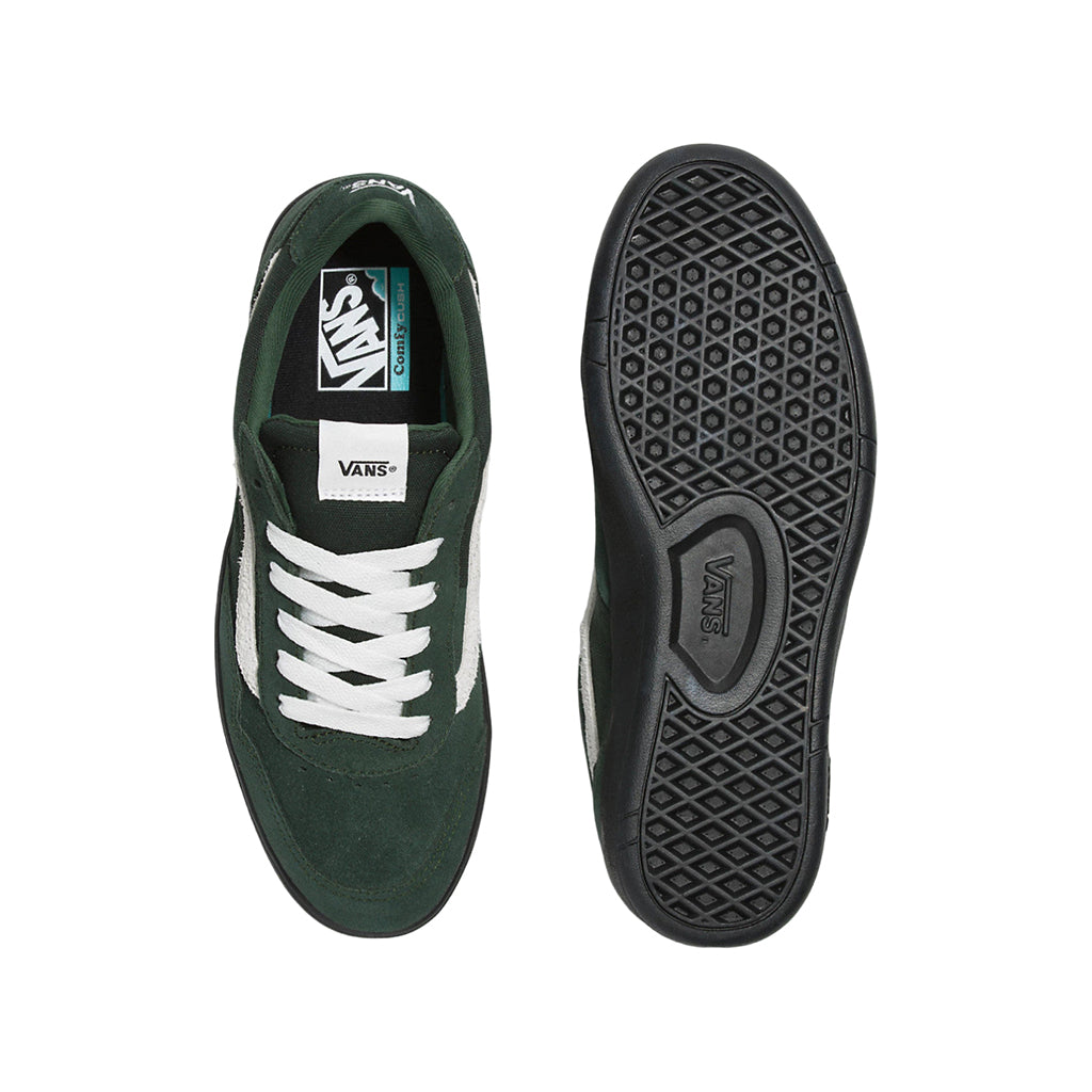 Green and white sneaker with black sole on a white background