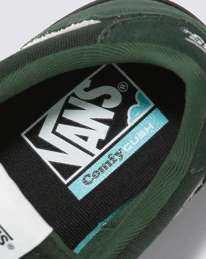 Close-up of a Vans shoe with 'Comfy Cush' label on a gray background