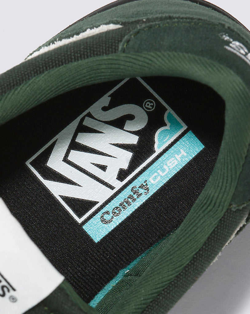 Close-up of a Vans shoe with 'Comfy Cush' label on a gray background