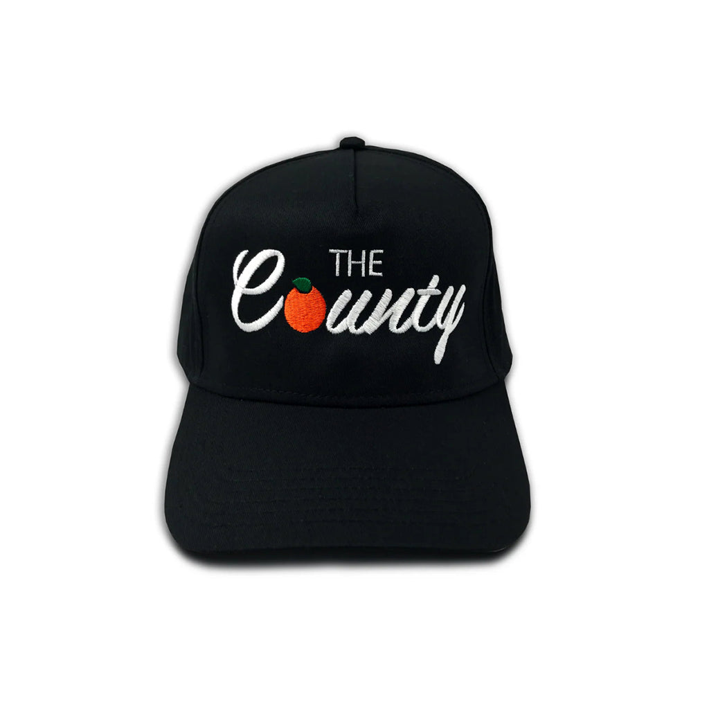 Black cap with 'The County' logo on a white background