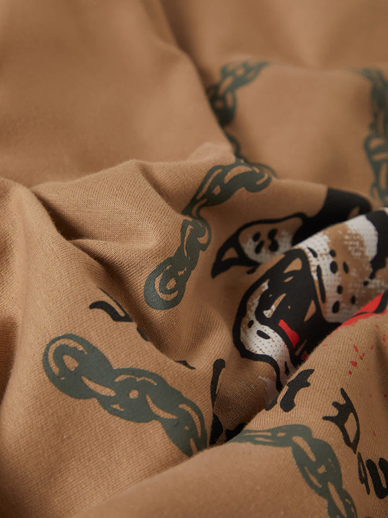 Close-up of brown fabric with black and white panther designs.