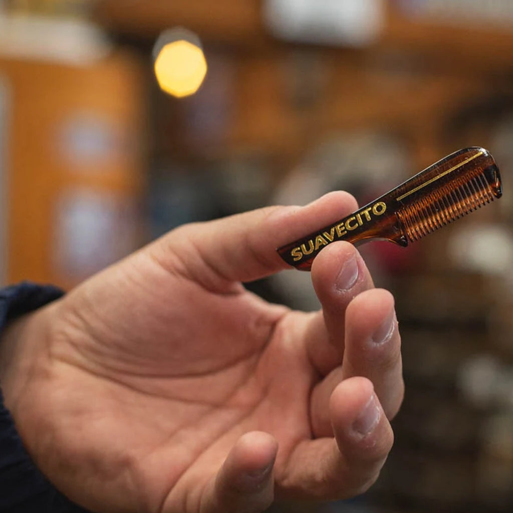 Model holding the Deluxe Amber Mustache Comb 