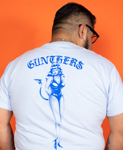 Person wearing a white t-shirt with blue graphics and text on an orange background