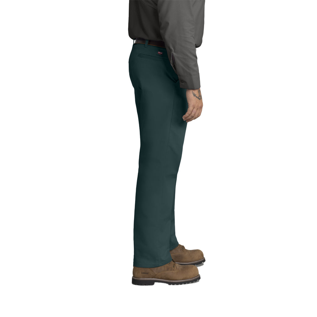 Person wearing dark green pants and brown shoes on a white background