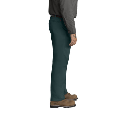 Person wearing dark green pants and brown shoes on a white background