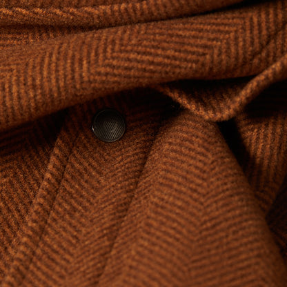 Close-up of brown textured fabric with a button