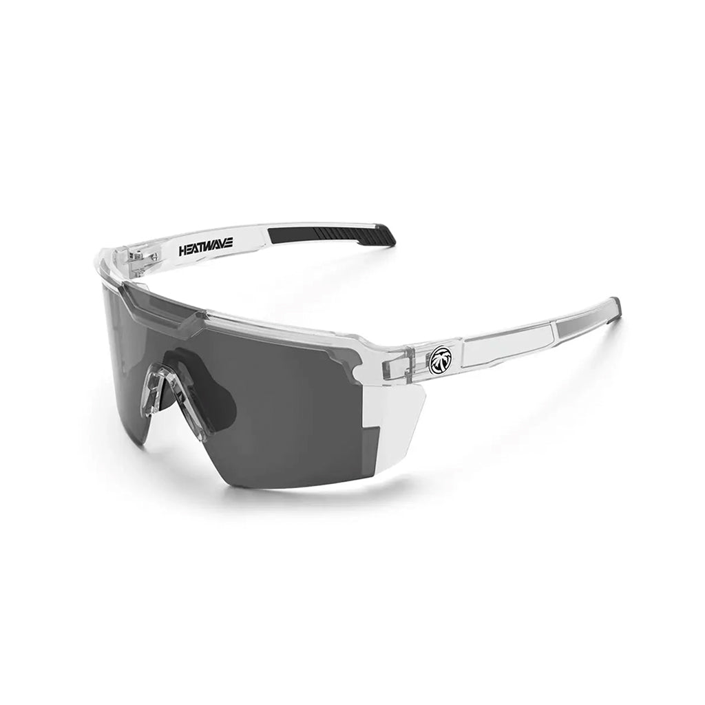 Sunglasses with clear frame and dark lenses on a white background