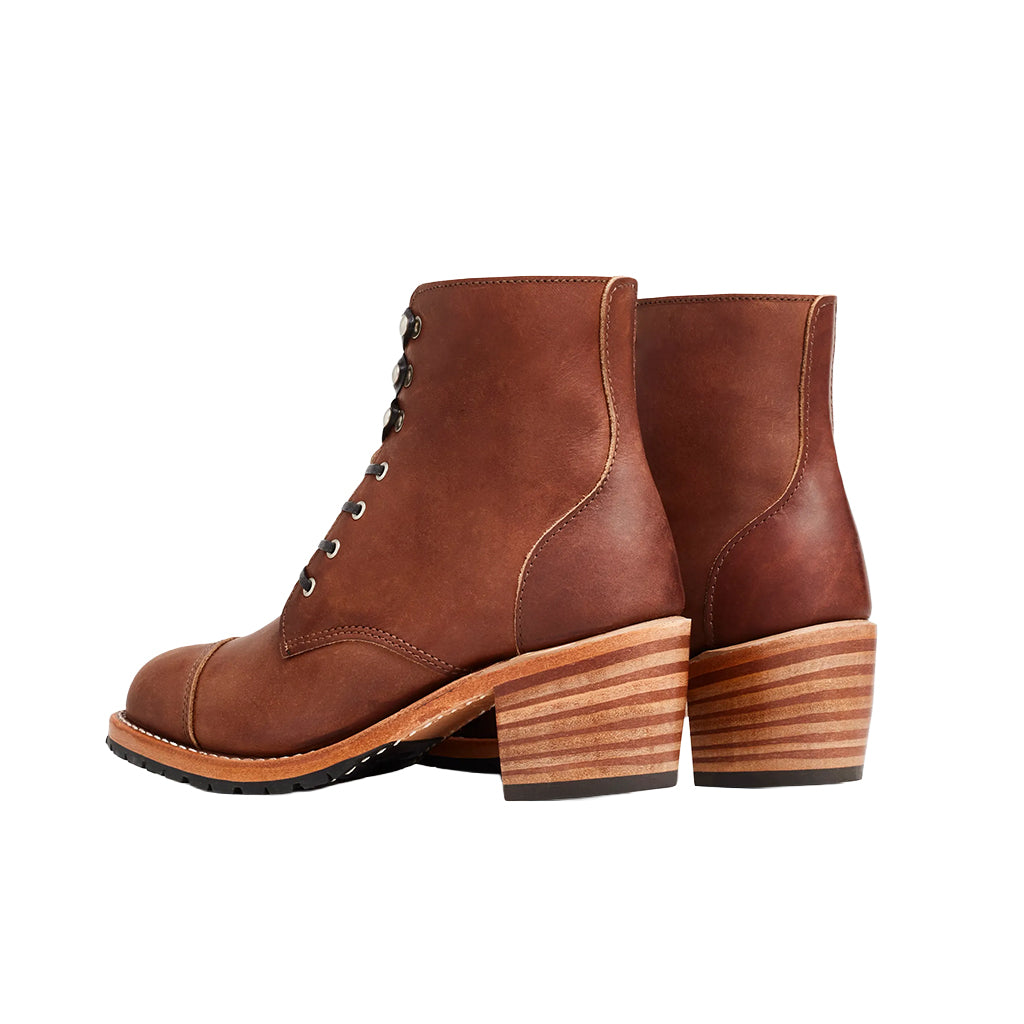 Brown leather ankle boots with wooden heel on a white background