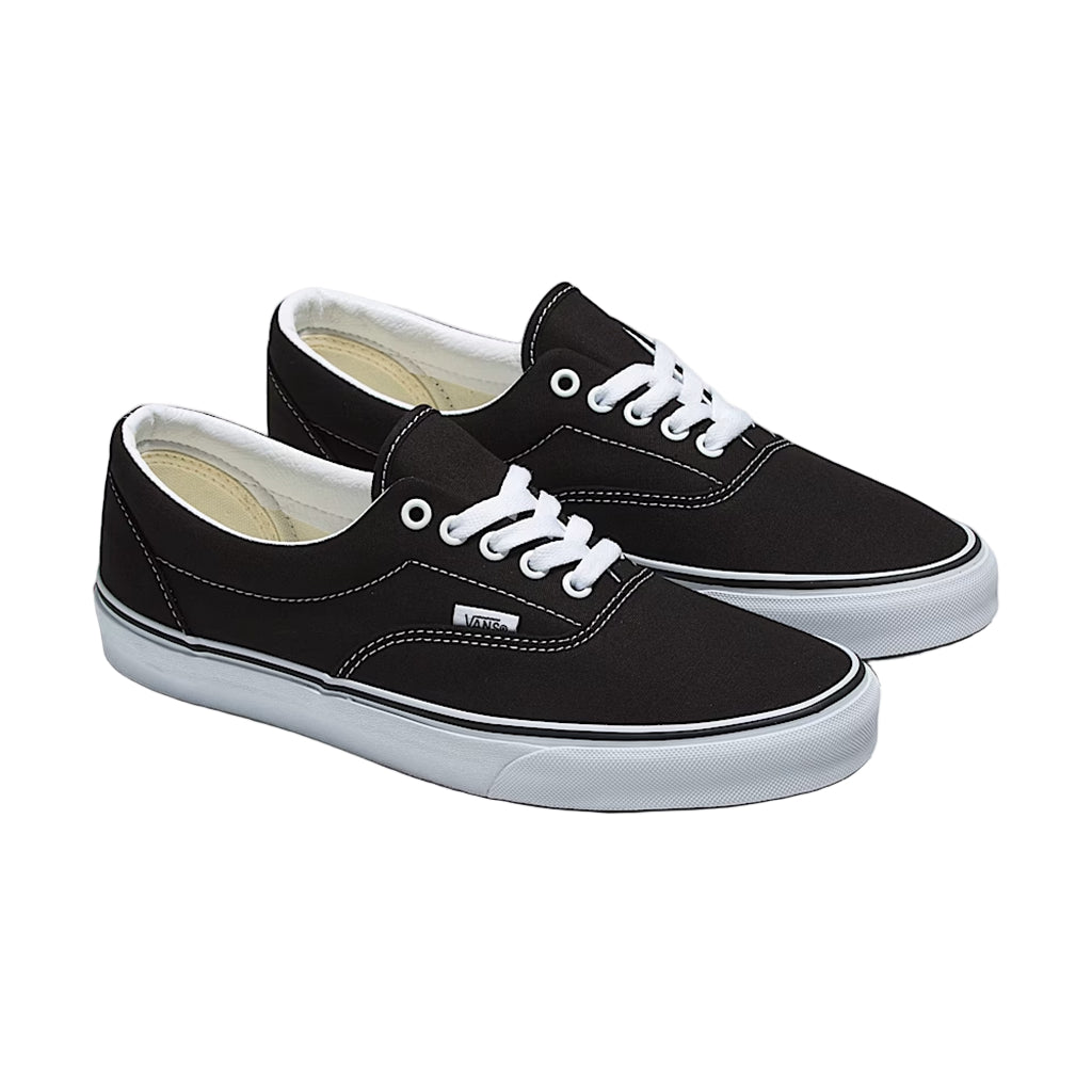 Black sneakers with white laces on a white background