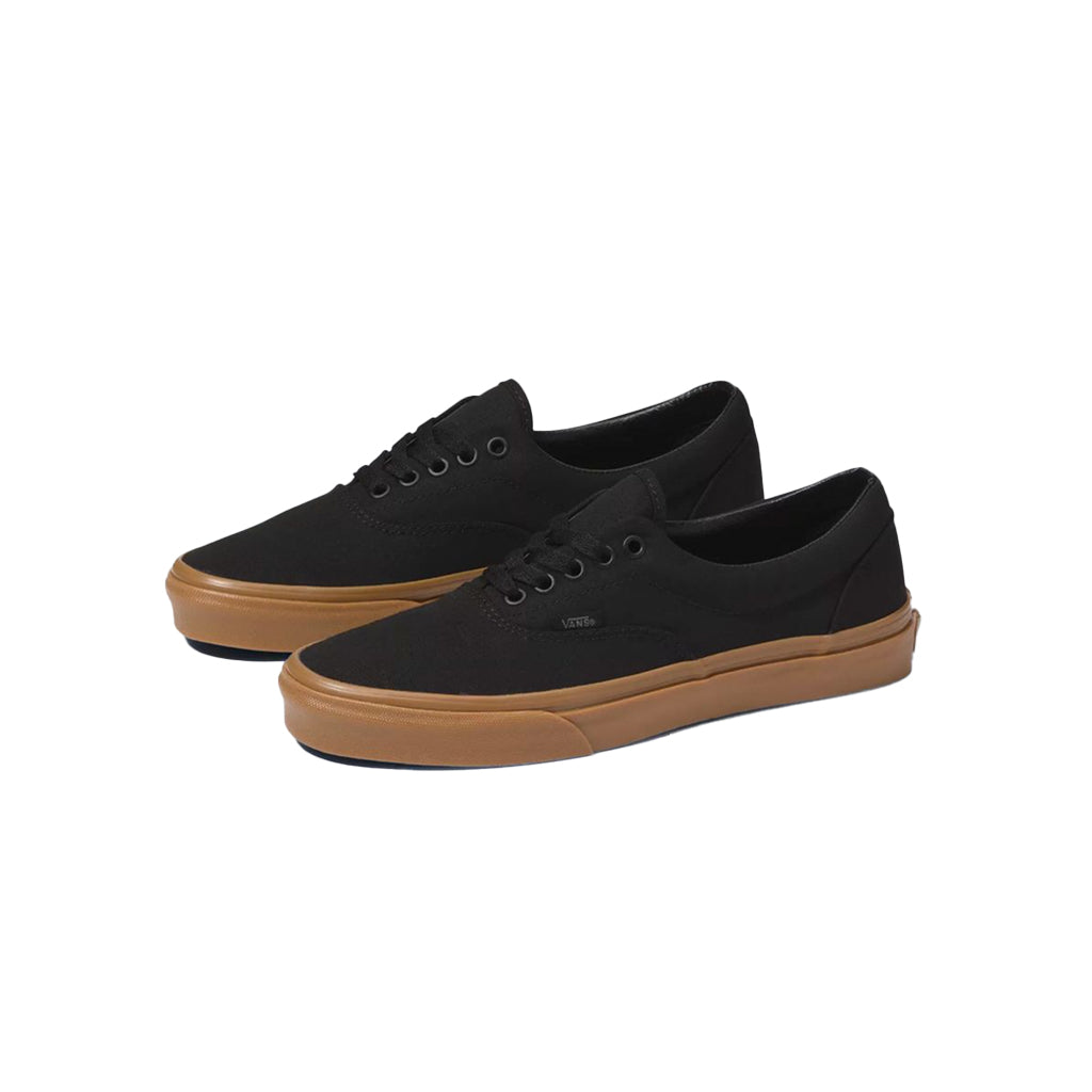 Black sneakers with brown soles on a white background