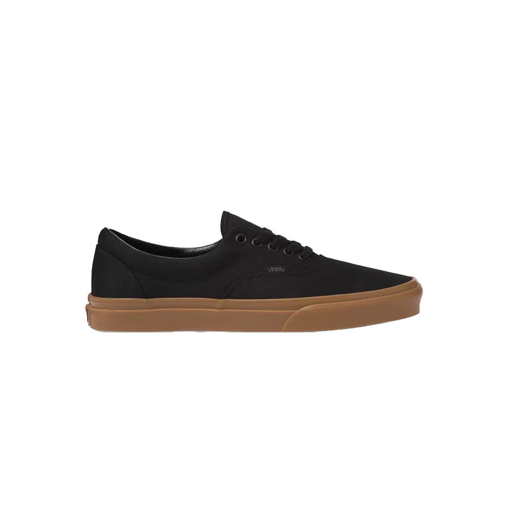 Black sneaker with brown sole on a white background